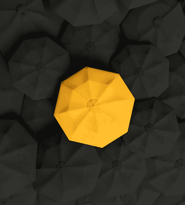 A single gold umbrella standing out among dark umbrellas